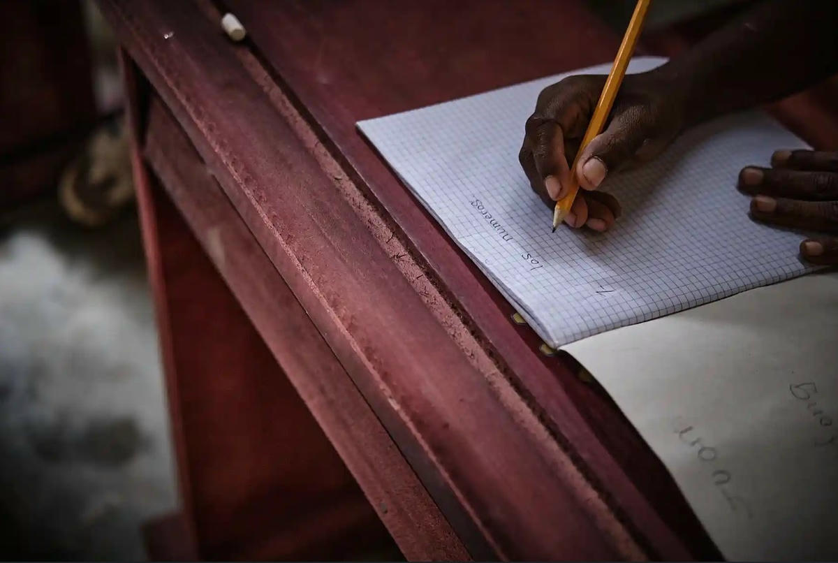 Một học sinh đang viết vào vở của mình. Ảnh: Diego Menjibar Reynes.