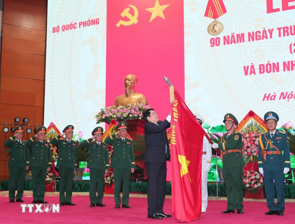 Chủ tịch nước Lương Cường gắn Huân chương Hồ Chí Minh lên cờ truyền thống của Dân quân tự vệ Việt Nam tại Lễ kỷ niệm 90 năm Ngày truyền thống Dân quân tự vệ (28/3/1935-28/3/2025), ngày 26/3. (Ảnh: Trọng Đức/TTXVN)