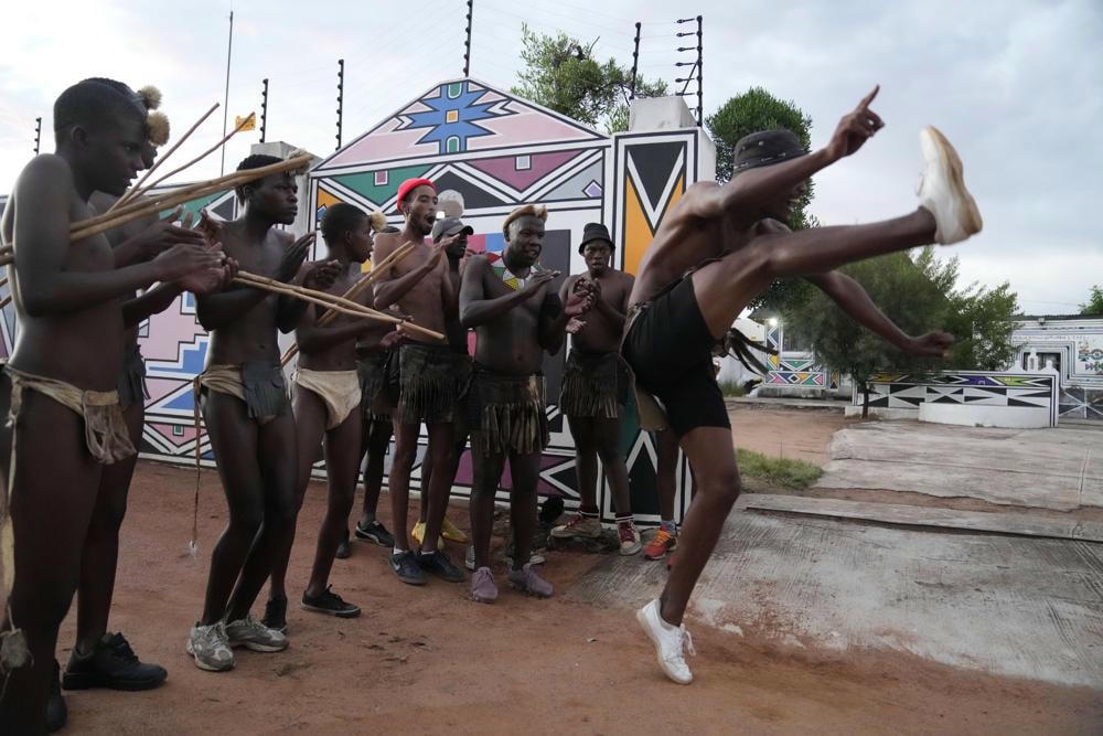 Bà Mahlangu cùng những thanh niên trẻ Ndebele nhảy múa. Ảnh: AP.