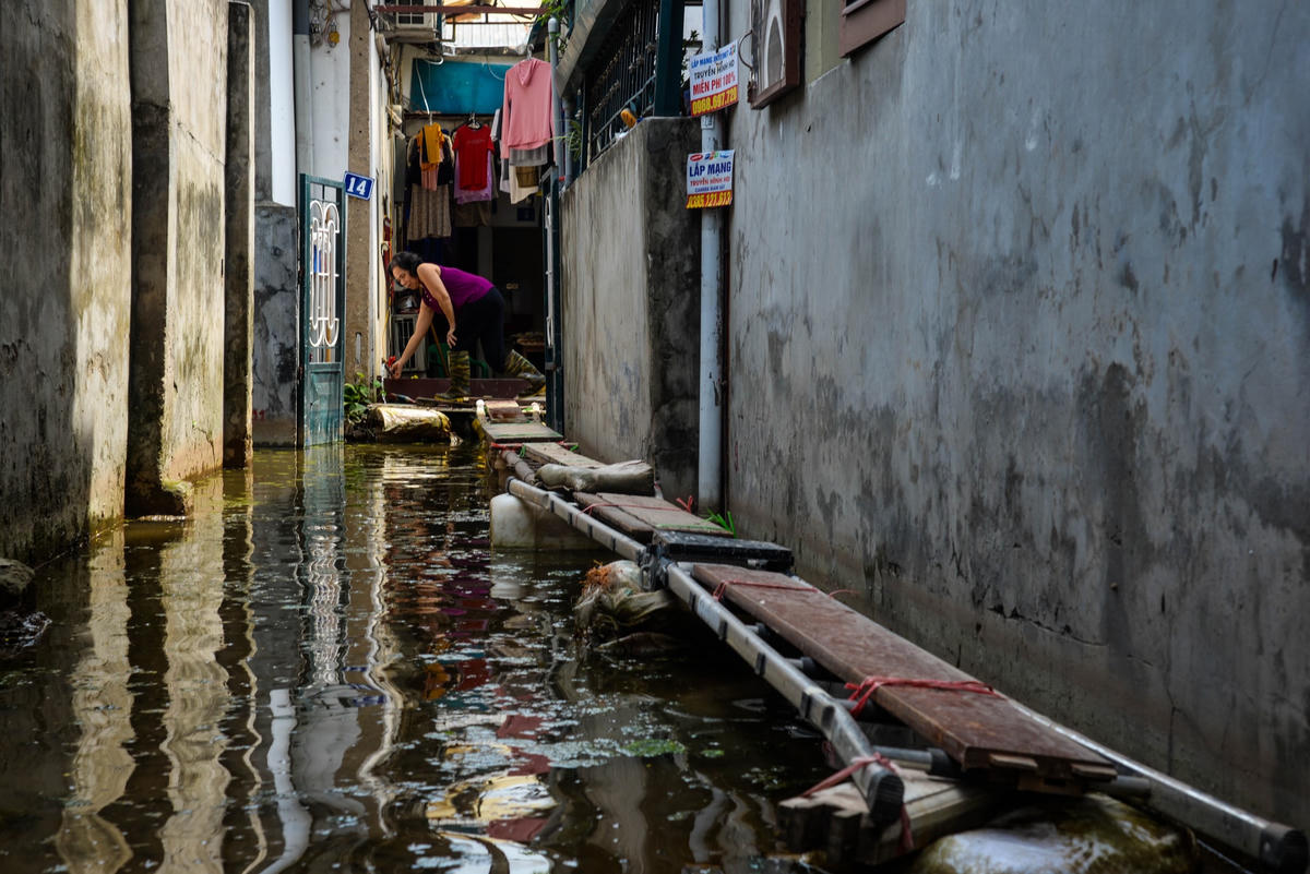 Tại ngõ 139 Âu Cơ, nơi chịu tình trạng ngập nặng nhất, muốn tiến sâu vào trong con ngõ phải đi qua những chiếc cầu khỉ được dựng một cách tạm bợ để đối phó với dòng nước.