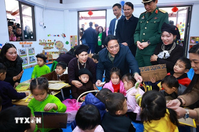 Thủ tướng Phạm Minh Chính thăm trẻ em tại Điểm trường liên cấp Mầm non và Tiểu học mới của thôn Làng Nủ, xã Phúc Khánh, huyện Bảo Yên, tỉnh Lào Cai được xây dựng bên trong khu tái định cư thôn Làng Nủ. (Ảnh: Dương Giang/TTXVN) ttxvn-thu-tuong-pham-minh-chinh-du-le-khanh-thanh-du-an-tai-thiet-thon-lang-nu-22-8.jpg