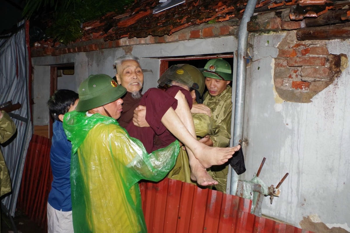 Công an tỉnh Ninh Bình hỗ trợ di dời người dân phường Lý Thường Kiệt đến nơi ở an toàn. Ảnh: CANB