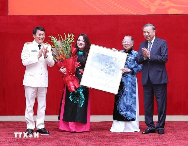 Đại tướng Lương Tam Quang, Uỷ viên Bộ Chính trị, Bí thư Đảng uỷ Công an Trung ương, Bộ trưởng Bộ Công an tặng bức ảnh lưu niệm và chúc mừng gia đình Thượng tướng Bùi Thiện Ngộ. (Ảnh: Thống Nhất/TTXVN) ttxvn-tong-bi-thu-to-lam-du-le-truy-tang-danh-hieu-anh-hung-llvtnd-cho-thuong-tuong-bui-thien-ngo-8246622-2.jpg