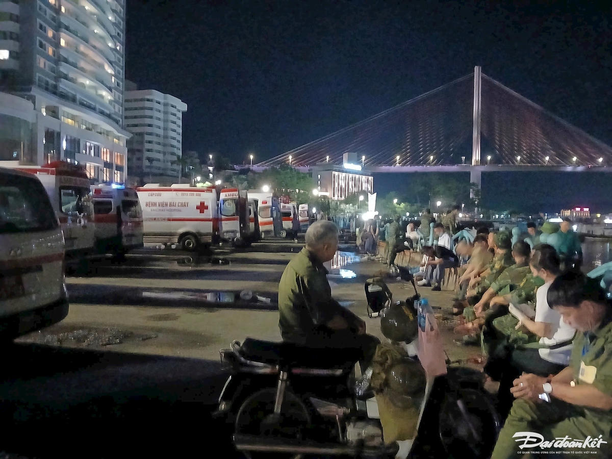 Trên bờ, ác lực lượng chức năng và người dân vẫn dõi chờ nạn nhân trong đêm 19/7. Ảnh: Nguyễn Quý.