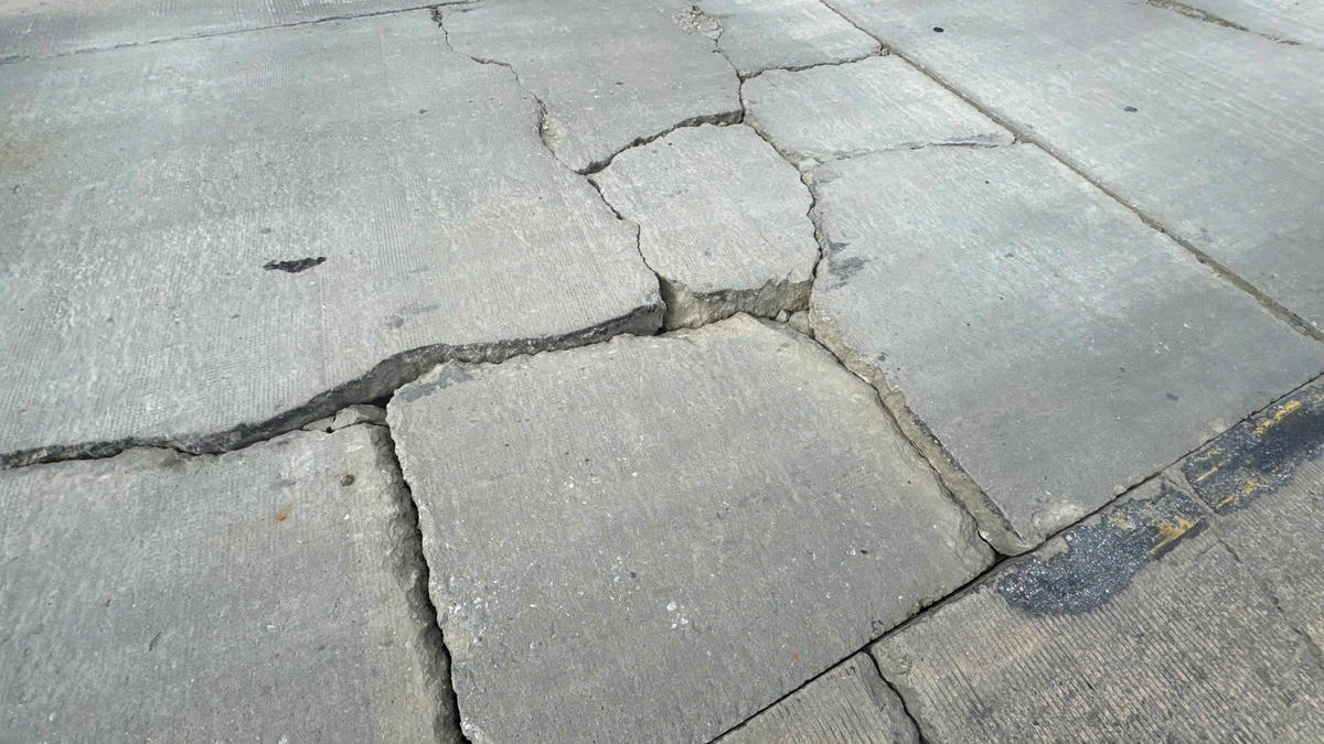 Nhiều vết nứt xuất hiện trên bề mặt đường quốc lộ 14, đoạ qua đèo Lò Xo. Ảnh: Nguyễn Tín.