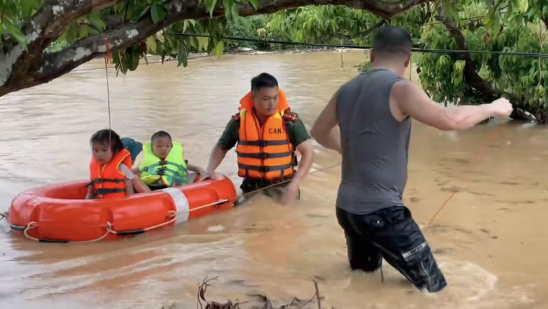 Lực lượng chức năng hỗ trợ người dân vùng ngập lụt xã Tuấn Sơn di chuyển đến nơi an toàn. Ảnh: CTV.