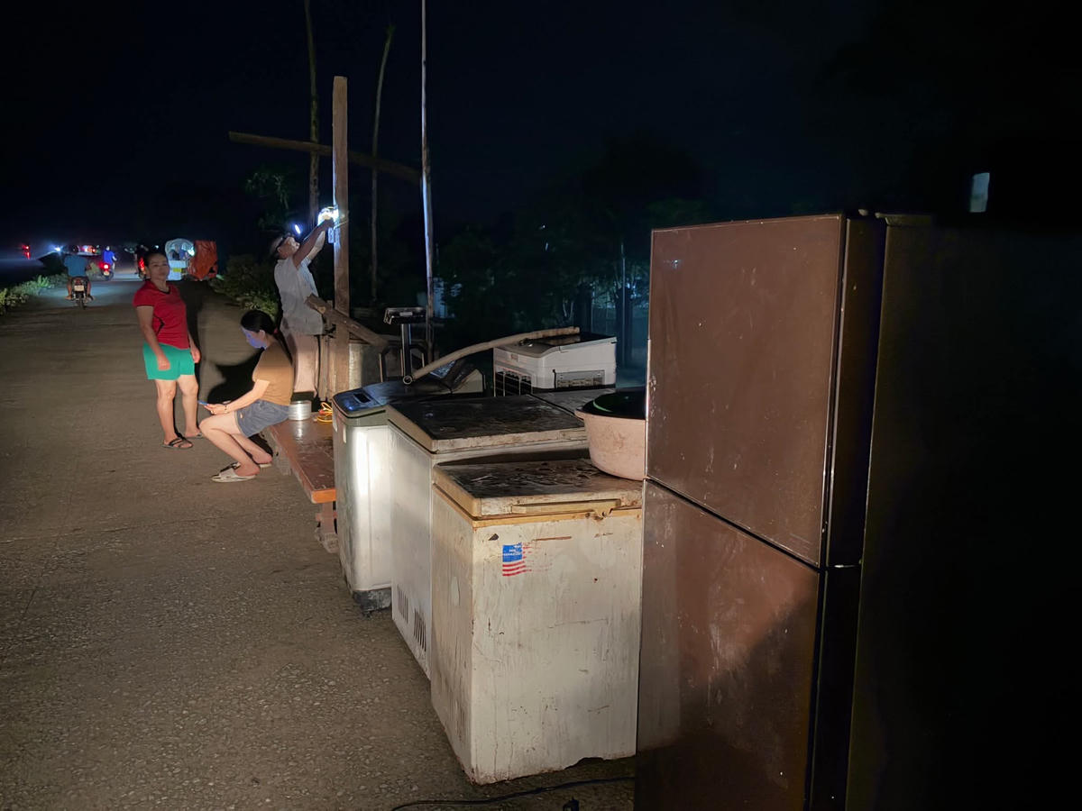 Người dân ven sông Bưởi khẩn trương di dời tài sản lên mặt đê đêm 30/9. Ảnh: Kim Tân