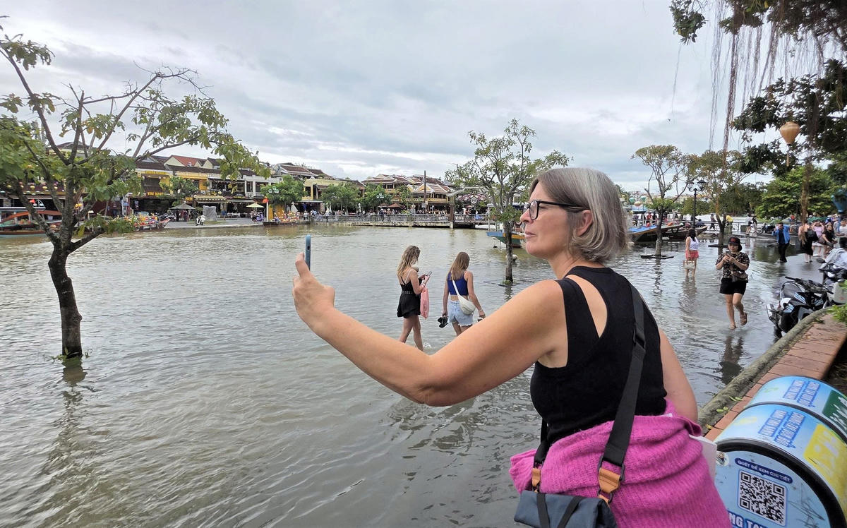 Du khách đang chụp cảnh nước sông Hoài dâng cao. Ảnh: Tấn Thành.