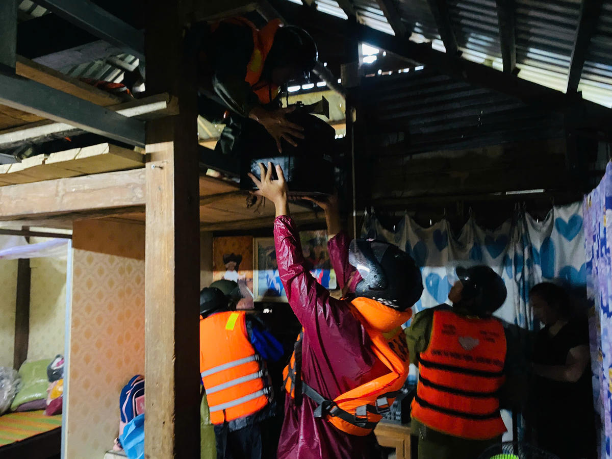 Lực lượng chức năng xã Thượng Đức đưa đồ đạc giúp người dân đến địa điểm an toàn. Ảnh: CV.