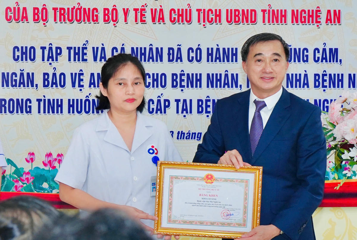 Thứ trưởng Bộ Y tế Trần Văn Thuấn trao Bằng khen của Bộ Y tế cho đại diện Khoa Sơ sinh (Bệnh viện Sản Nhi Nghệ An). Ảnh: TC