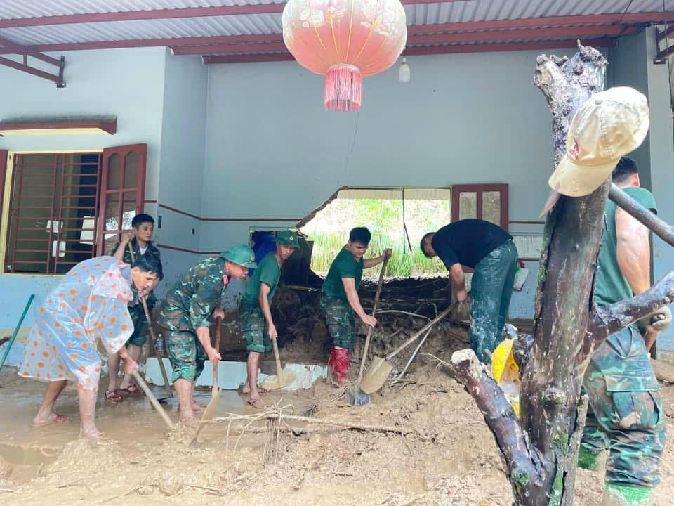 Bộ đội dọn bùn đất sau lũ. Ảnh: Hoàng Nam Thành.