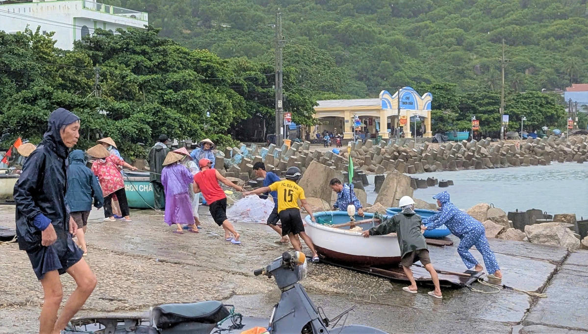 Ngư dân tỉnh Gia Lai khẩn trương đưa ghe thuyền lên bờ tránh bão số 13. Ảnh: CV.