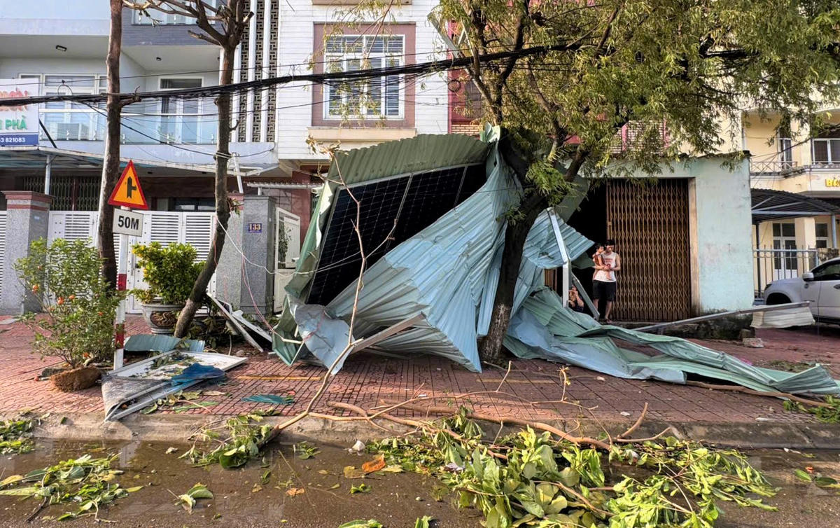 Mái tôn của người dân bị gió bão số 13 thổi bay nằm trên các cành cây cối. Ảnh: CV.