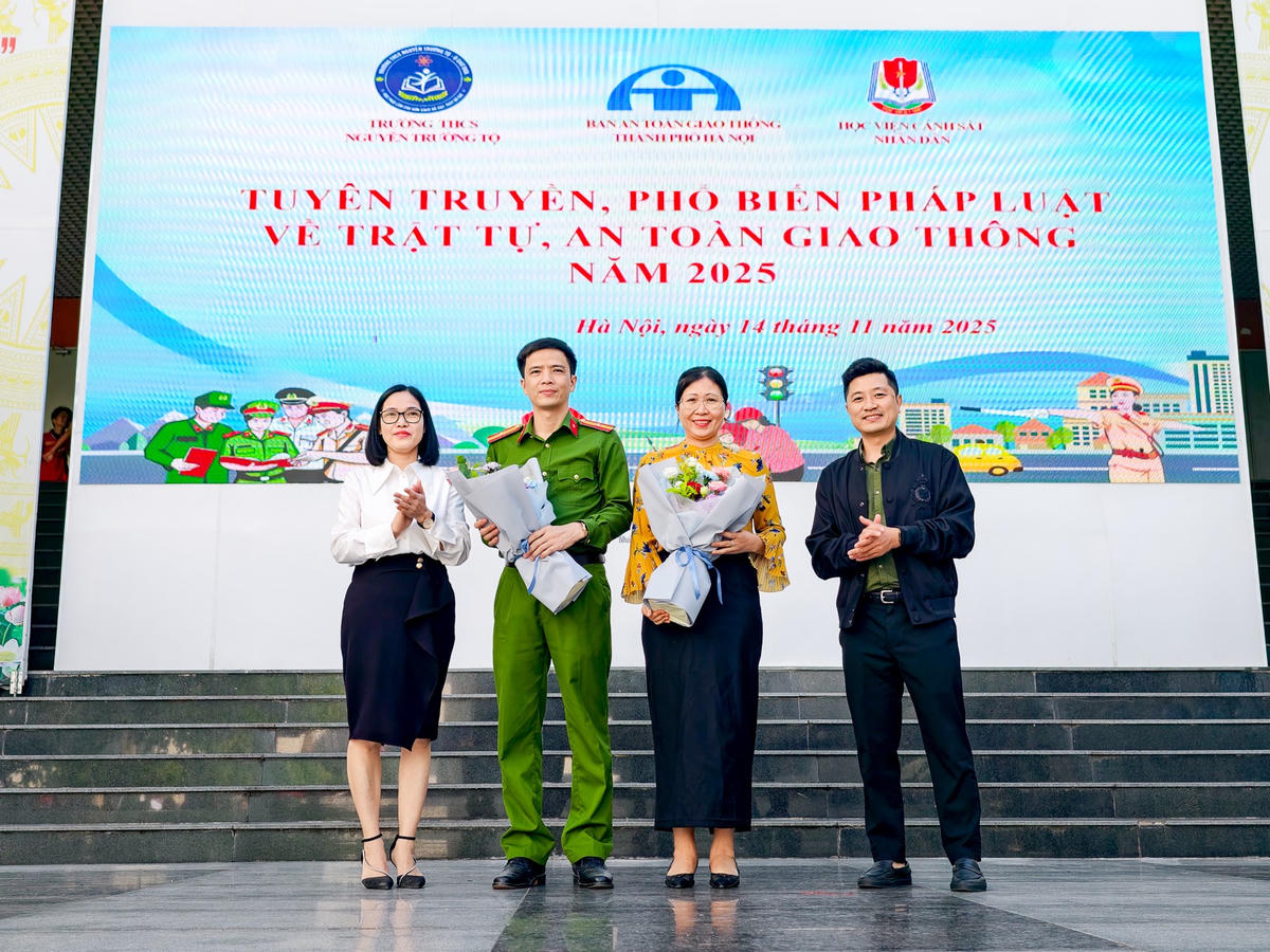 Lãnh đạo Trường THCS Nguyễn Trường Tộ tặng hoa, cảm ơn Ban An toàn giao thông TP Hà Nội và Học viện Cảnh sát nhân dân đã có buổi chia sẻ về kiến thức ATGT.