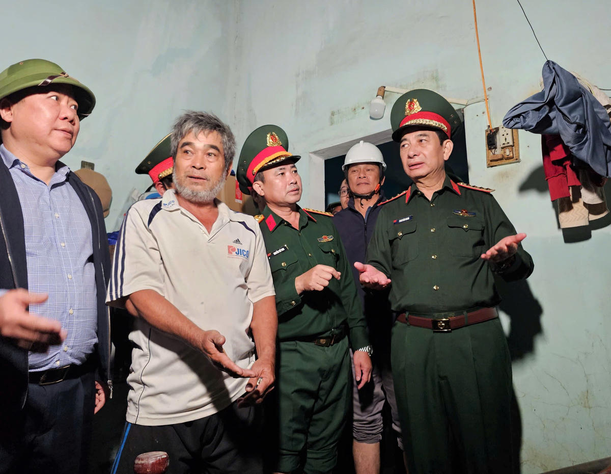 Đại tướng Phan Văn Giang (bên phải) và&nbsp;ông Nguyễn Phi Long (bên trái), Phó Bí thư Đảng ủy MTTQ và các đoàn thể Trung ương thăm hỏi người dân tỉnh Gia Lai về tình hình thiệt hại do mưa lũ gây ra. Ảnh: T.Thành.