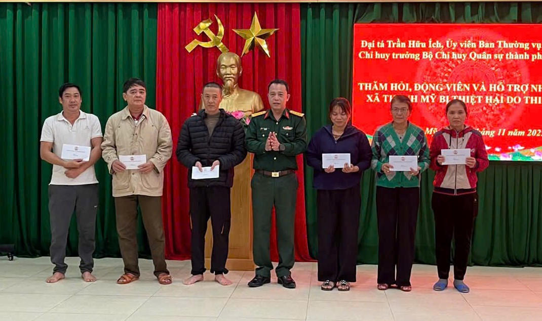 Đại tá Trần Hữu Ích, Chỉ huy trưởng Bộ CHQS TP Đà Nẵng tặng quà cho người dân xã Thạnh Mỹ bị thiệt hại đợt mưa lũ vừa qua. Ảnh: CV.