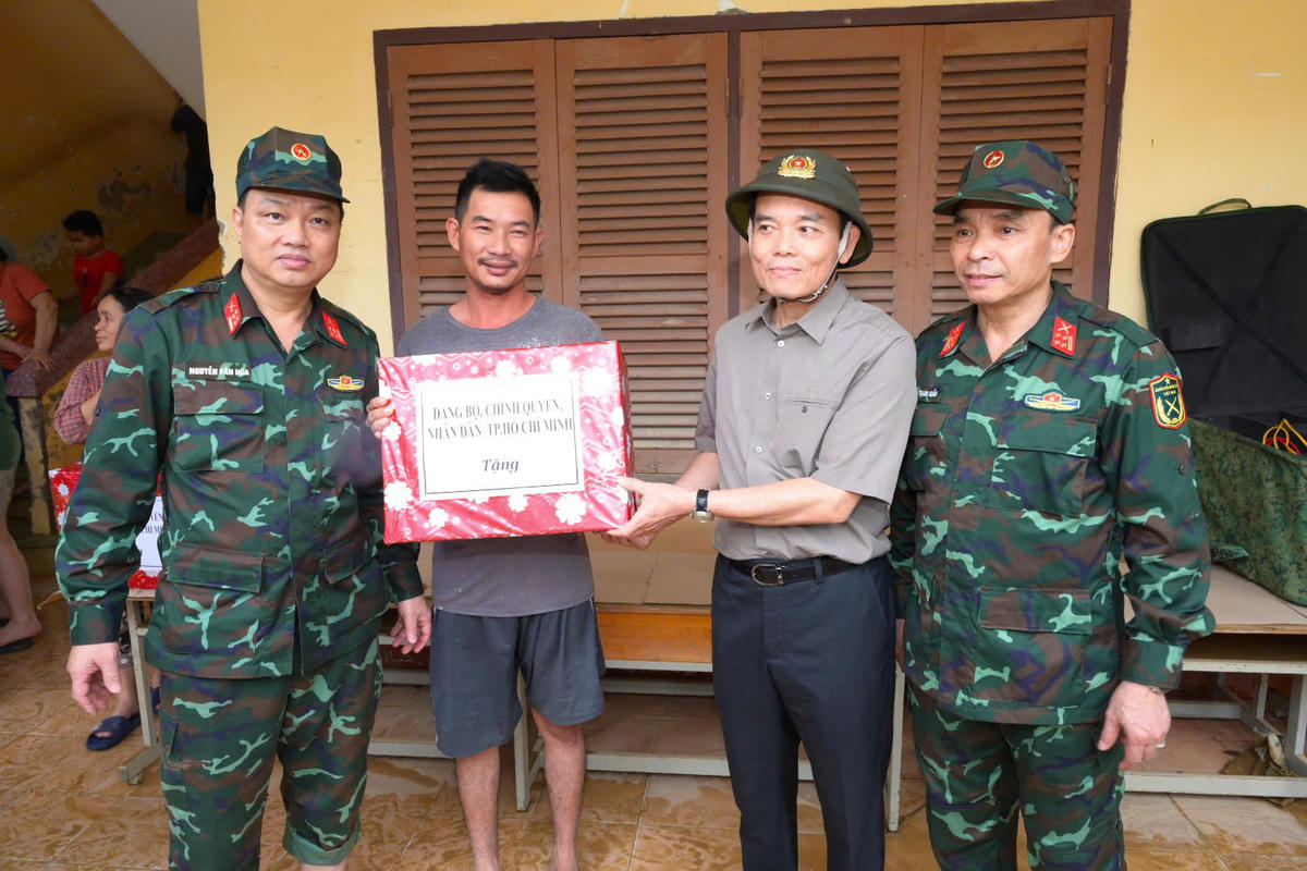 Bí thư Thành uỷ TP Hồ Chí Minh Trần Lưu Quang tới thăm hỏi, động viên và trao tận tay cho bà con vùng lũ Khánh Hòa những phần quà nhỏ của người dân thành phố. Ảnh: HP.