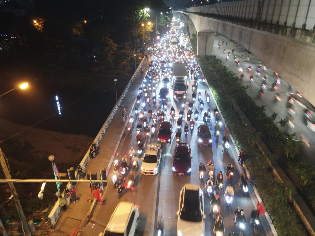 Mặc dù "đi bão" ăn mừng, người hâm mộ bóng đá vẫn không quên tuân thủ Nghị định 168/2024, dừng xe đúng quy định trước tín hiệu đèn đỏ giao thông trên phố.