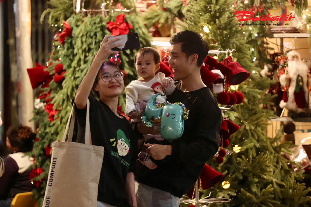 Nhiều gia đình đưa con nhỏ đi chơi sớm, tranh thủ ghi lại những khoảnh khắc đáng nhớ bên cây thông.