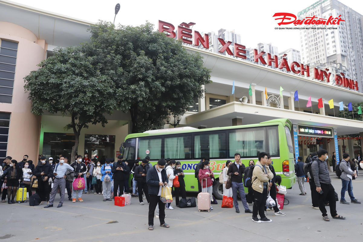 Hành khách đứng chờ phía ngoài sảnh bến xe.