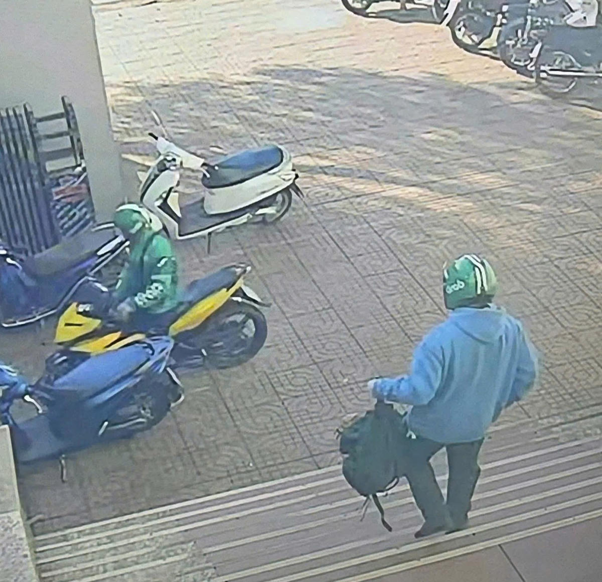 2 người đàn ông cướp tiền ngân hàng đi ra ngoài. Ảnh cắt từ clip.