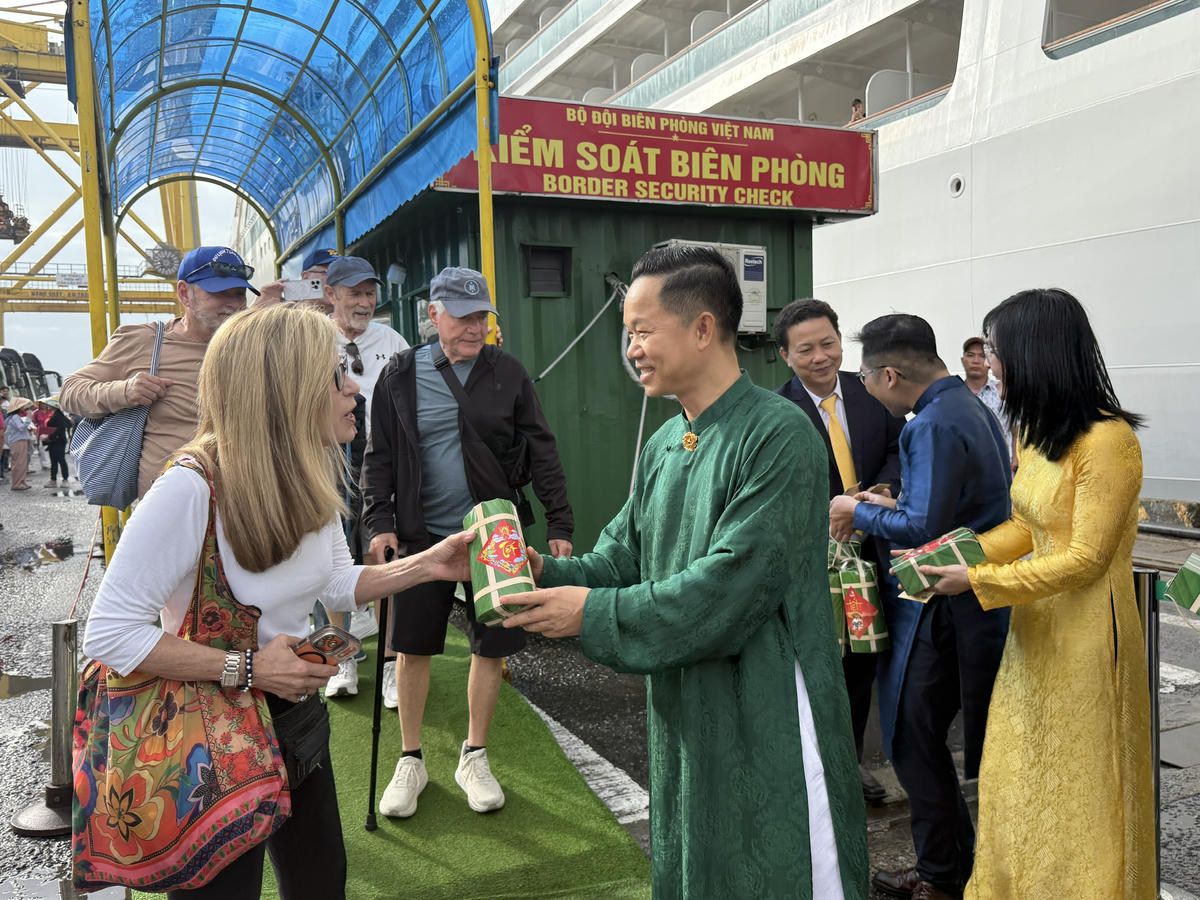 Ông Nguyễn Đức Quỳnh, Chủ tịch Hội Khách sạn Đà Nẵng, Tổng Giám đốc Furama Resort Đà Nẵng tặng quà năm mới cho du khách tại Cảng Tiên Sa. Ảnh: CV