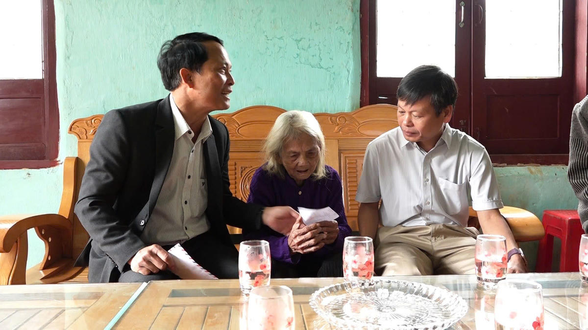 Lãnh đạo xã Tu Mơ Rông đưa phiếu cử tri cho Mẹ Việt Nam anh hùng Y Tría. Ảnh: CV.