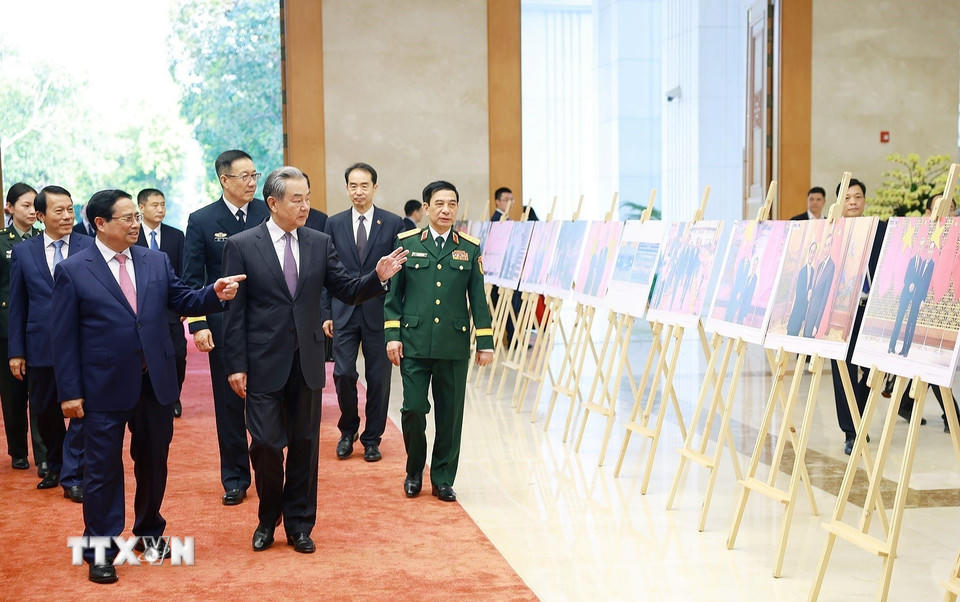 Thủ tướng Phạm Minh Chính và Bộ trưởng Ngoại giao, Quốc phòng, Công an Trung Quốc tham quan trưng bày ảnh về quan hệ hợp tác giữa hai nước Việt Nam-Trung Quốc do Thông tấn xã Việt Nam thực hiện. (Ảnh: Dương Giang/TTXVN)