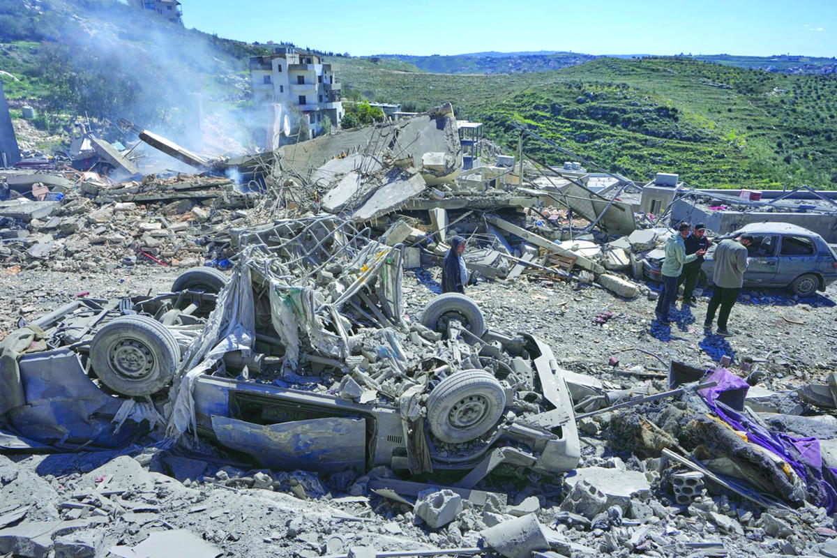 Người dân kiểm tra hiện trường nơi các cuộc không kích của Israel đã đánh trúng nhiều ngôi nhà tại làng Sir al-Gharbiyeh, miền nam Liban, Chủ nhật, ngày 8 tháng 3 năm 2026. Ảnh APMohammed Zaatari.