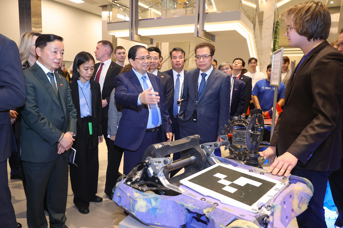 Thủ tướng Phạm Minh Chính và Phó Thủ tướng Trần Hồng Hà xem sản phẩm nghiên cứu của sinh viên Trường Đại học Khoa học và Công nghệ Moscow - Ảnh: VGP/Nhật Bắc