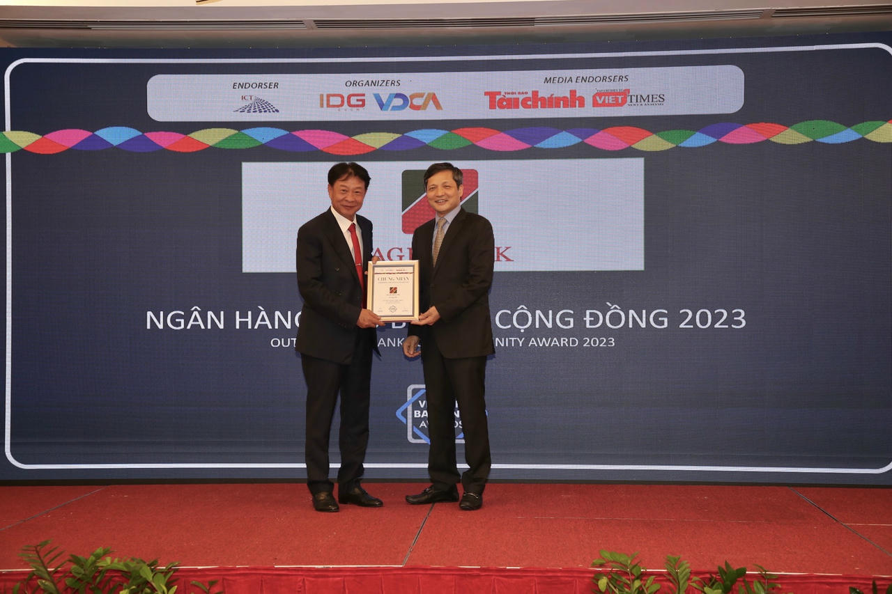 Ông Vũ Viết Ngoạn – Chủ tịch Ủy ban giám sát Tài chính Quốc gia (phải) trao Giải thưởng “Ngân hàng tiêu biểu vì cộng đồng” cho đại diện Agribank.