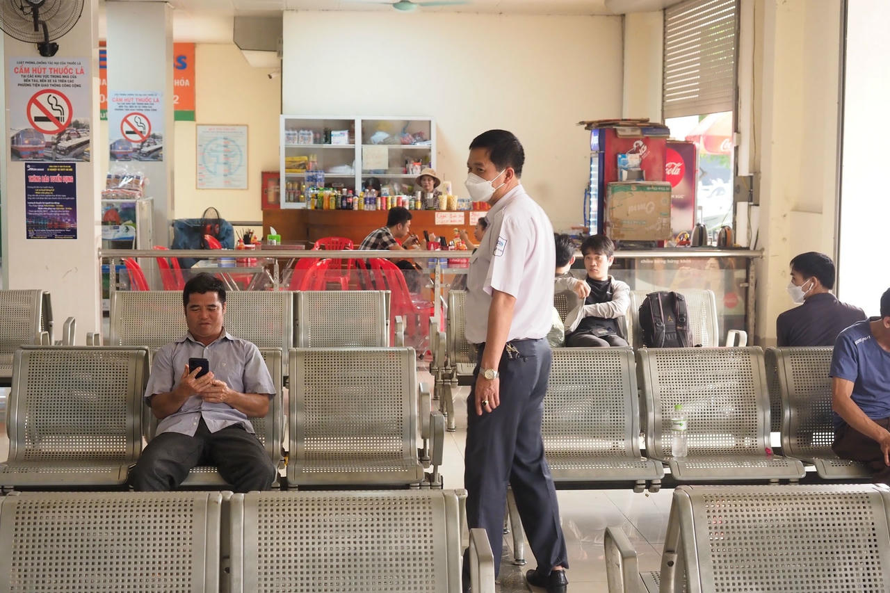 Nhân viên Bến xe nhắc nhở người dân đeo khẩu trang. 