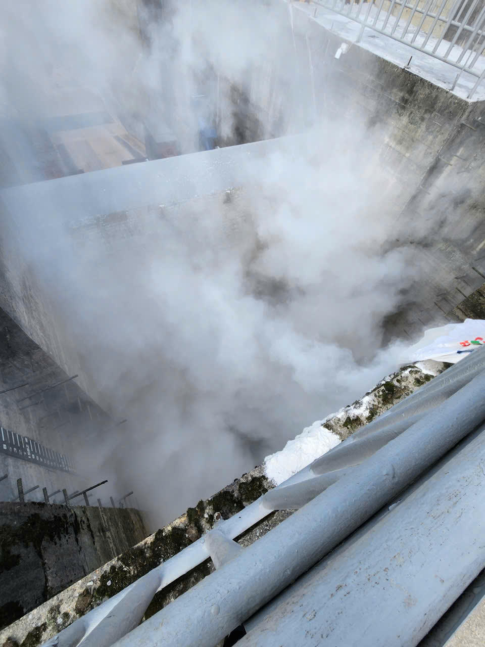 Những nơi công nhân khó tiếp cận sẽ tiến hành đổ vôi từ trên cao xuống. Ảnh: Quý Hùng.